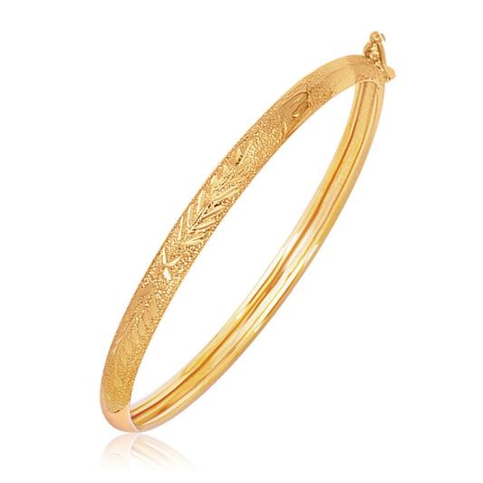 Children's 14k yellow gold textured dome bangle with diamond cuts by Avera Group