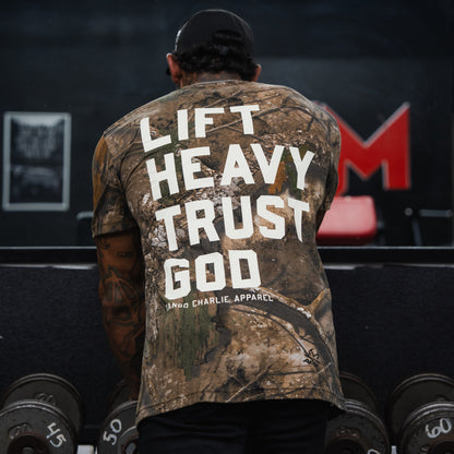 Lift Heavy. Trust God. - Realtree Premium Camo Tee by Tango Charlie Apparel