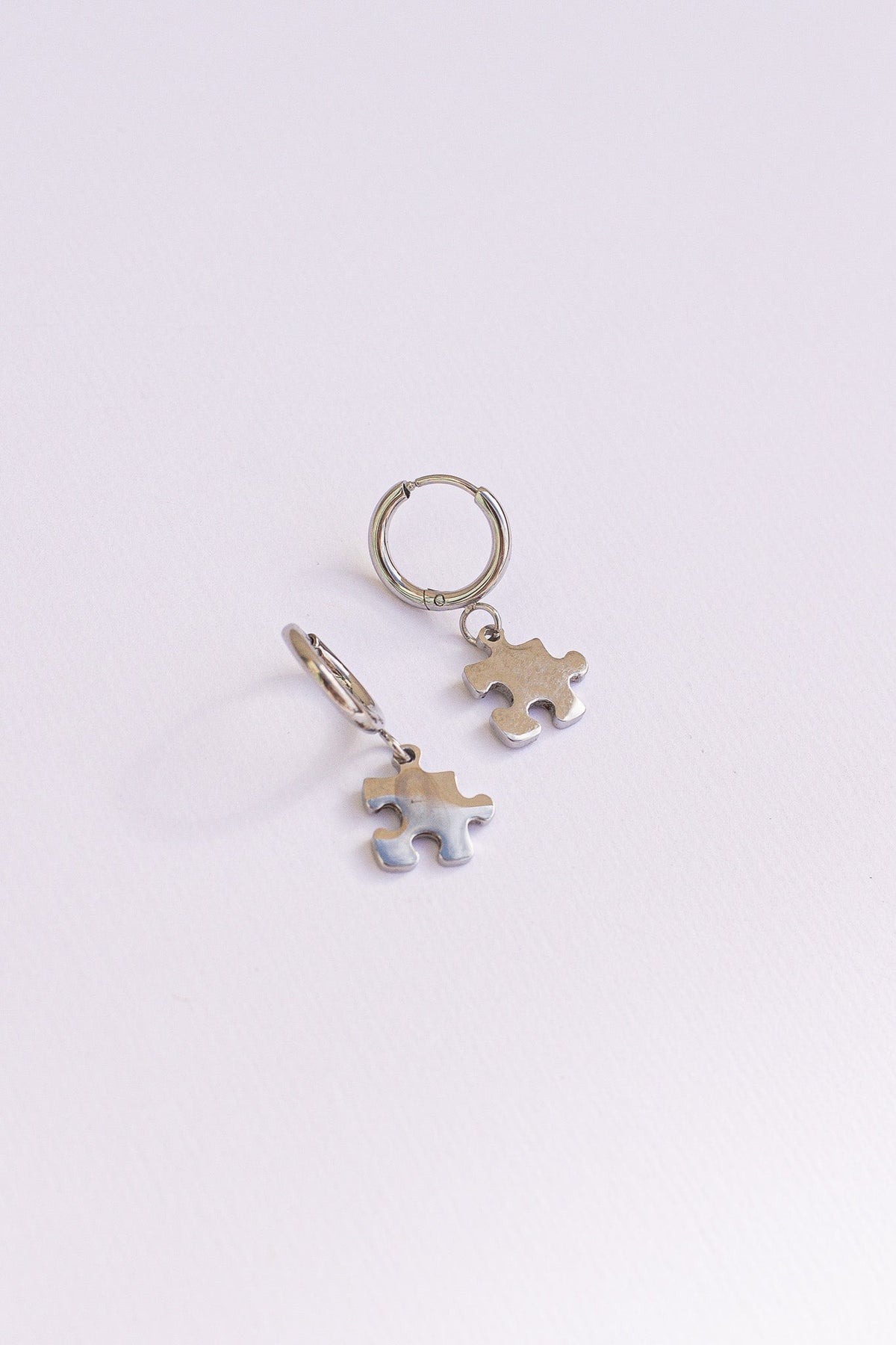 Puzzle Piece Huggie Hoops by Rose & Clay