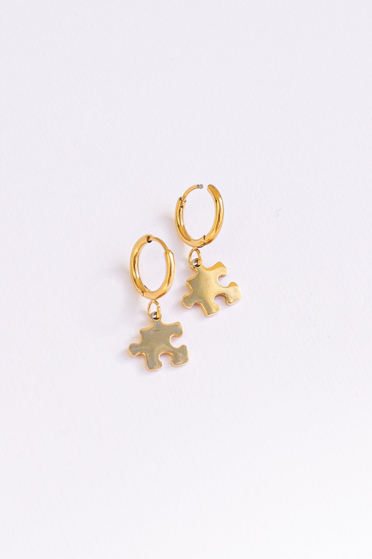 Puzzle Piece Huggie Hoops by Rose & Clay