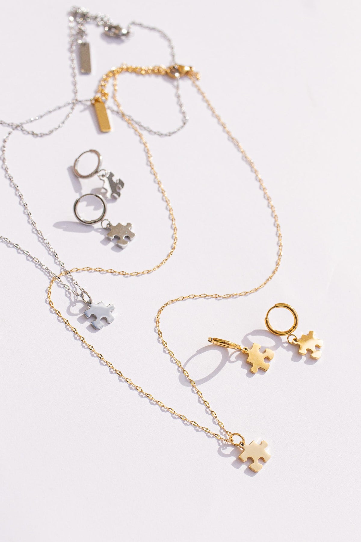 Puzzle Piece Huggie Hoops by Rose & Clay