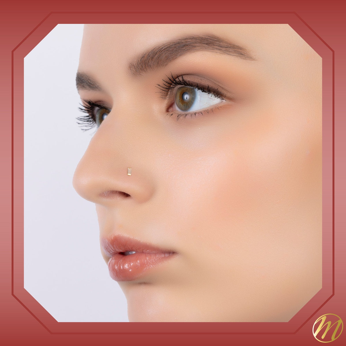 Model wearing 14k yellow gold baguette CZ nose stud, 20 gauge by Massete