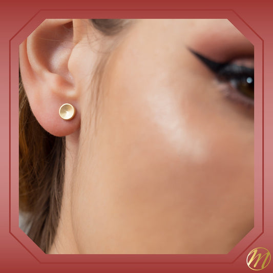 14k yellow gold satin concave button disc stud earrings by Massete, worn by a model, view 2