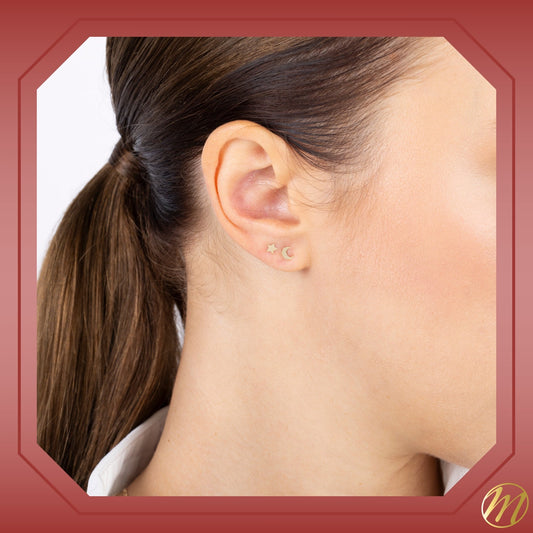 Model wearing 14k yellow gold small star stud earrings by Massete