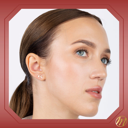 Model wearing 14k yellow gold small moon stud earrings by Massete