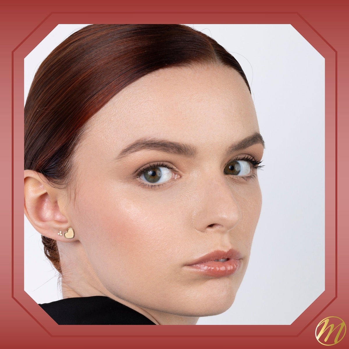 Model wearing 14k yellow gold matte finish heart stud earrings by Massete, view 4