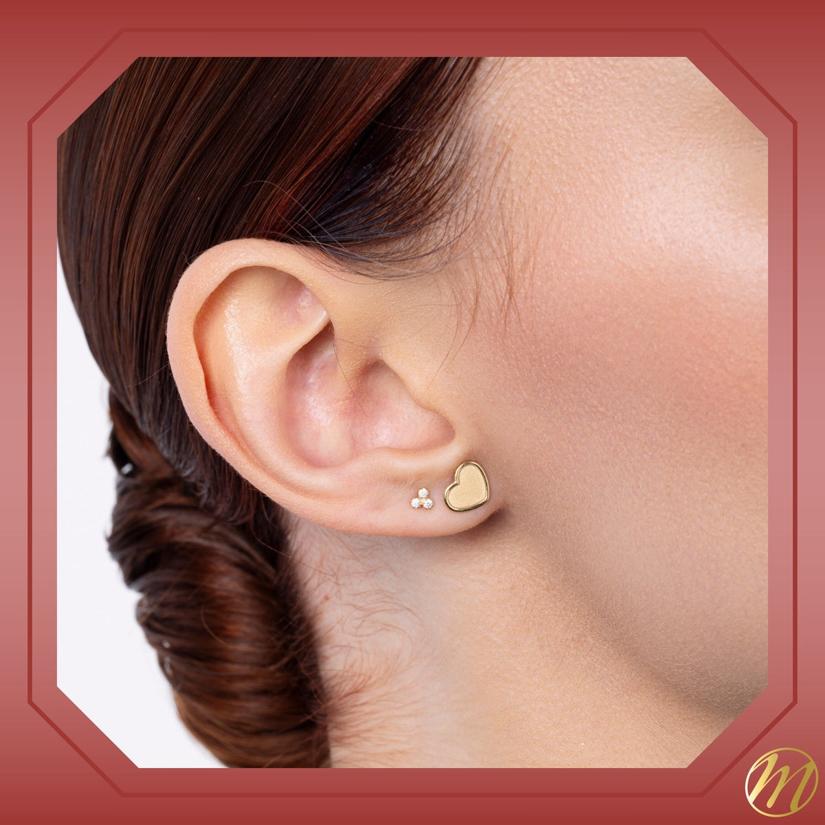 Model wearing 14k yellow gold matte finish heart stud earrings by Massete, view 2