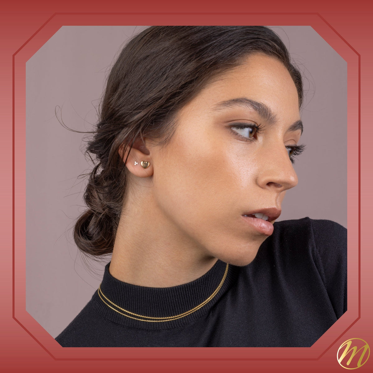 Model wearing 14k yellow gold puff heart stud earrings by Massete, view 4