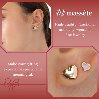 Model wearing 14k yellow gold puff heart stud earrings by Massete, view 3
