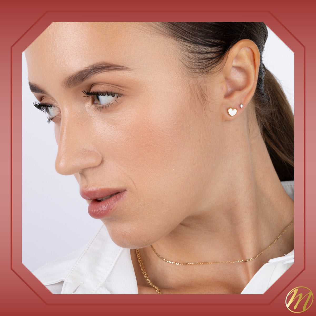 Model wearing 14k yellow gold flat heart stud earrings with CZ by Massete, view 6