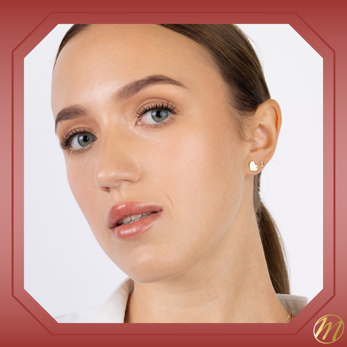 Model wearing 14k yellow gold flat heart stud earrings with CZ by Massete, view 5