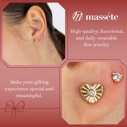 Model wearing 14k yellow gold fluted heart stud earrings with simulated diamond center by Massete, view 3