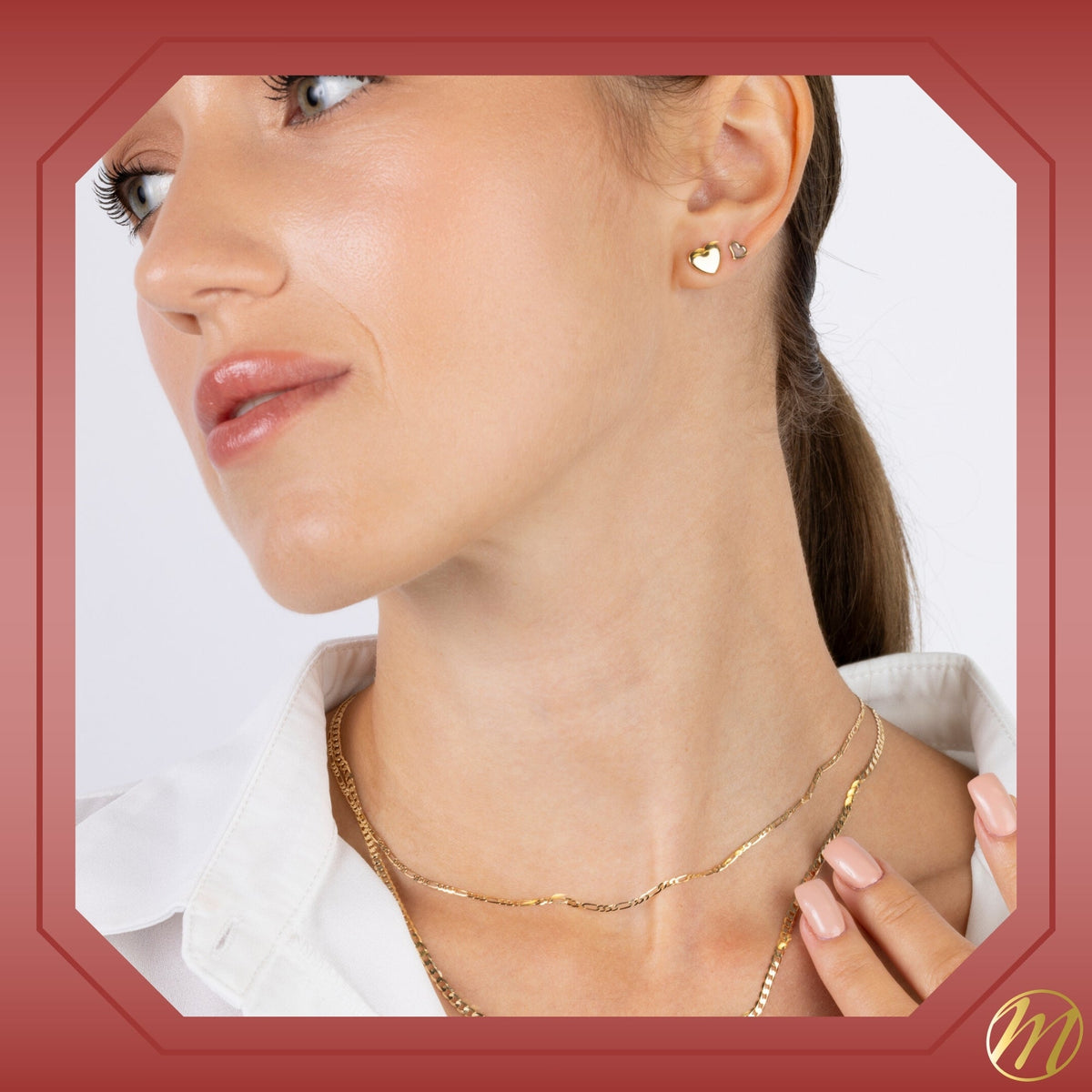 Model wearing 14k yellow gold heart twist stud earrings with mother of pearl by Massete, view 4