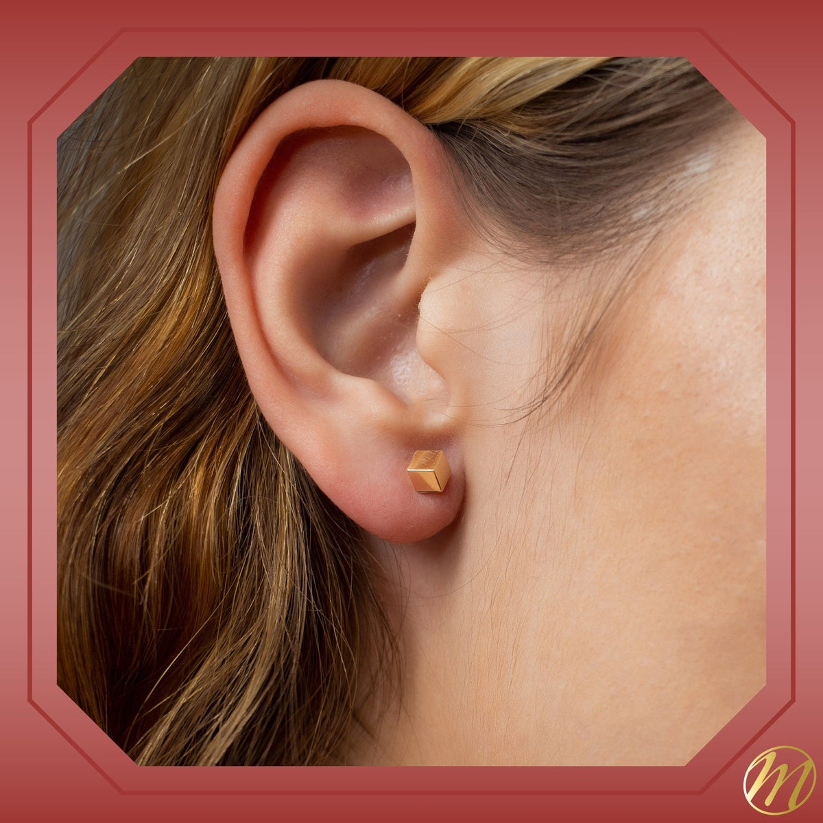 14k yellow gold 4mm cube stud earrings set on an angle by Massete, worn by a model, view 5