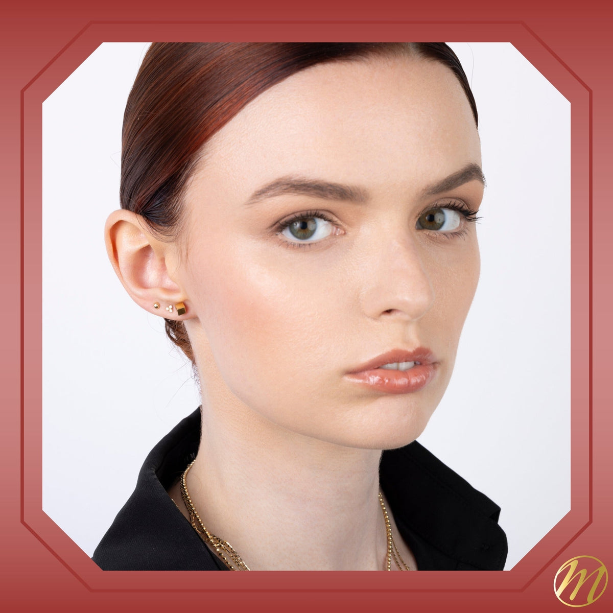 14k yellow gold 4mm cube stud earrings set on an angle by Massete, worn by a model, view 4