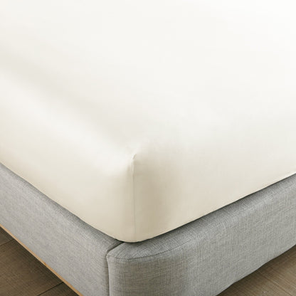 Corner detail of Whisper Organics 300 TC organic sateen fitted sheet in Natural