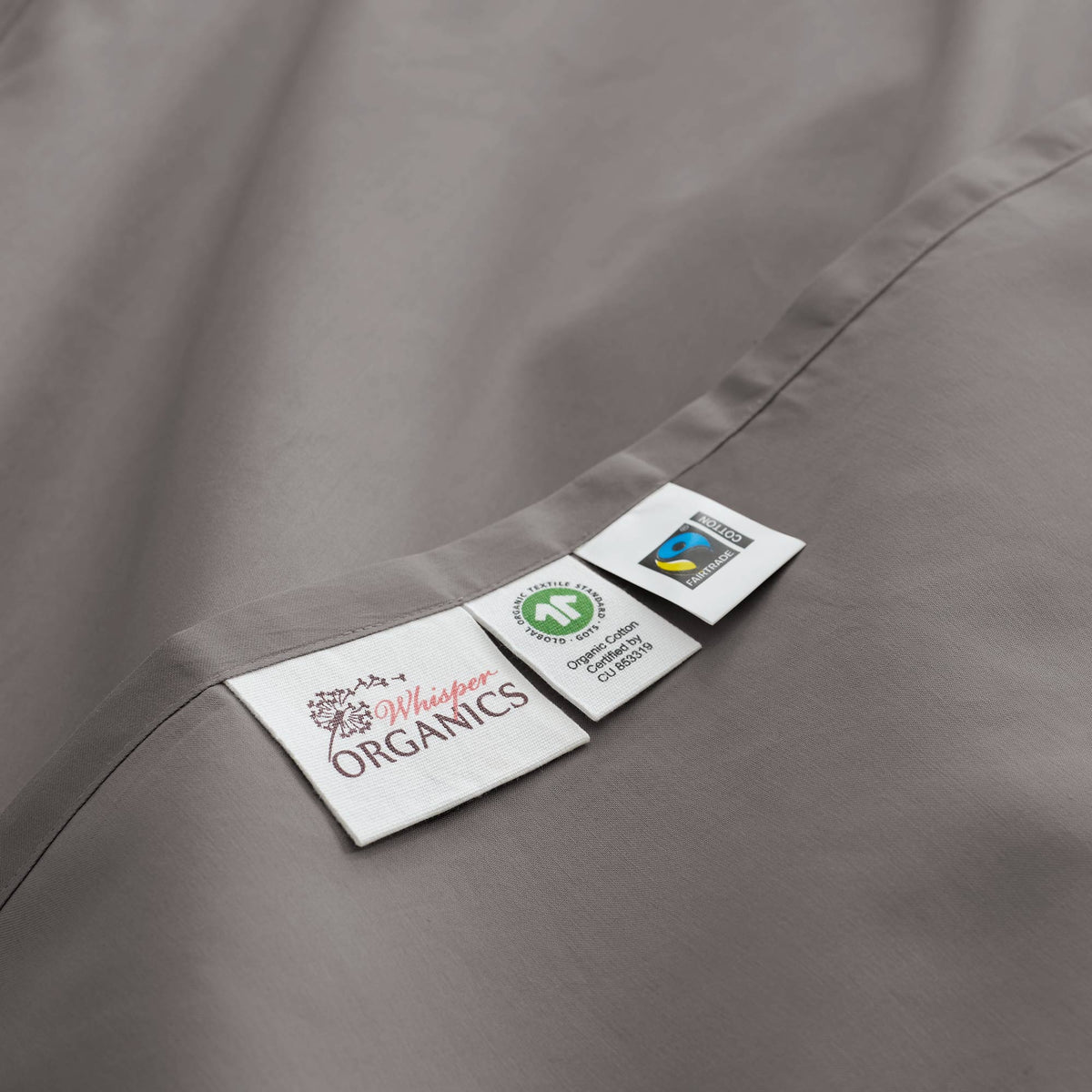 Tag detail of Whisper Organics 300 TC organic sateen flat sheet in Stone