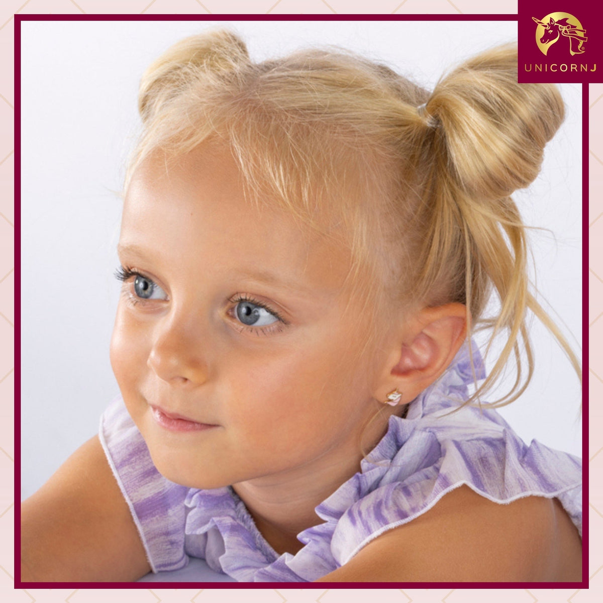 Model wearing Unicornj 14k yellow gold unicorn stud earrings with pink and white enamel, view 2