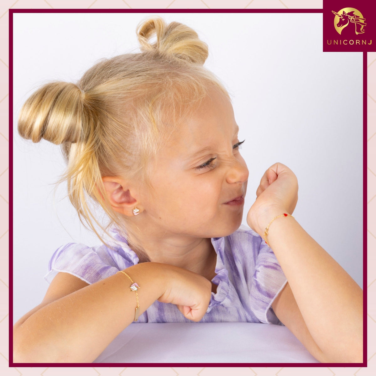 Model wearing Unicornj 14k yellow gold unicorn stud earrings with pink and white enamel, view 4