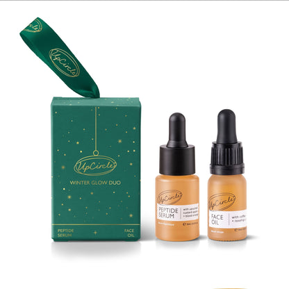 UpCircle Winter Glow bauble gift set with serum and face oil on white background