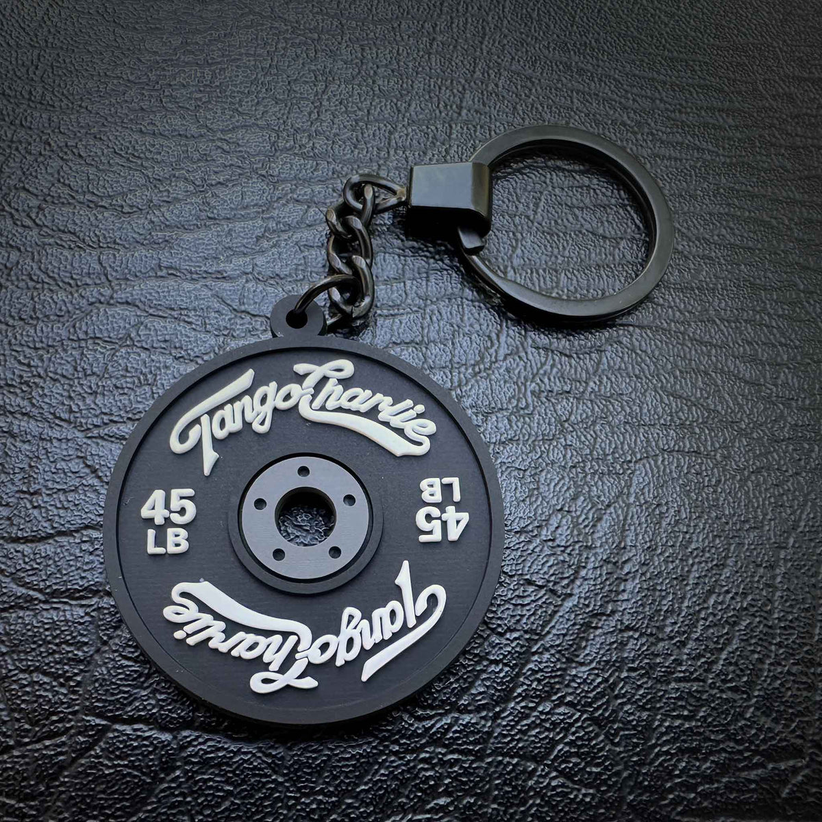 45 lb plate keychain in black by Tango Charlie Apparel
