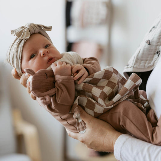 Little one with the Parker Baby Co. Rosewood Checker muslin lovey
