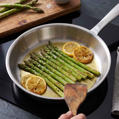 Alva stainless steel frying pan sauteing asparagus and lemon